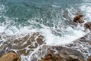 foaming sea water and waves on the Mediterranean coast natural water background