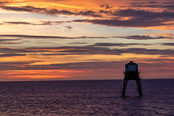 sunrise over a old lighthouse in the sea, Dovercourt low lighthouse, built in 1863 and discontinued...