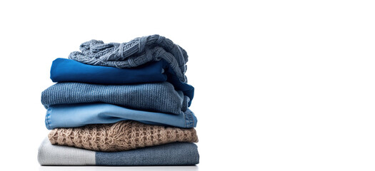 Stack of clothing jeans sweaters on a white background
