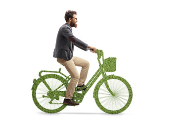Bearded man riding a bike made of green grass