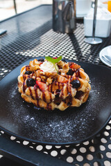 delicious waffles with strawberries and blueberries and maple syrup, waffle breakfast with berries, outdoor breakfast