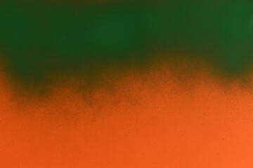 green spray paint on orange paper background - obrazy, fototapety, plakaty