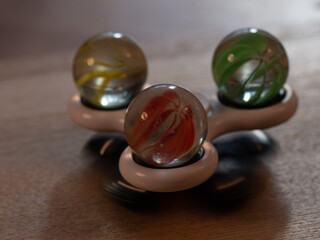 Three marbles on a spinner