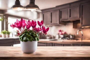 interior product display concept, cyclamen flower  on wooden table against blur hazy kitchen background - obrazy, fototapety, plakaty
