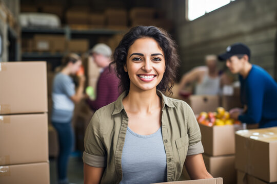Portrait of woman with charity box and group of volunteers at assistance center. Charity, donation, and volunteering concept.