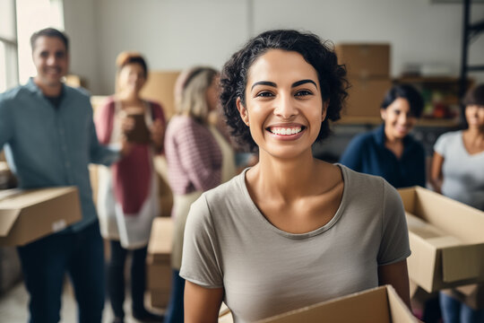 Portrait of woman with charity box and group of volunteers at assistance center. Charity, donation, and volunteering concept.