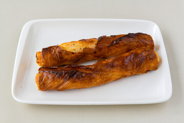 Turkish style meat stuffed filo dough borek served kol boregi. Cheese and minced pie are sliced on a marble background. Turkish name: Kol Boregi, ispanakli, kiymali, Su Boregi