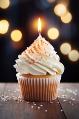 A delicious cupcake with a single lit candle on top. Perfect for birthday celebrations or special occasions.