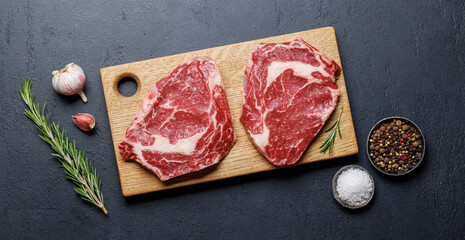 Raw ribeye steaks with savory spices