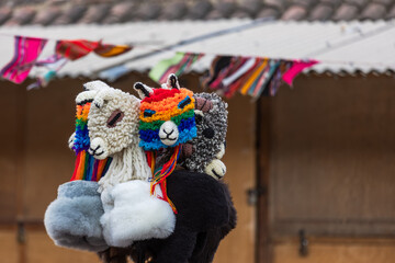 Fototapeta na wymiar Peruvian market. Different caps in the shape of heads of alpacas and llamas