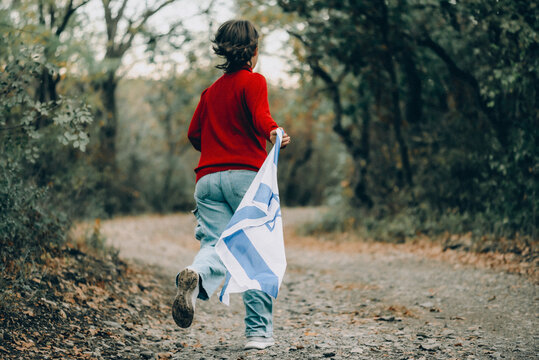 Energetic Young Girl Running with the Israeli Flag