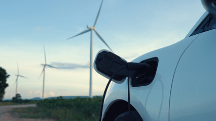 Progressive future energy infrastructure concept of electric vehicle being charged at charging...
