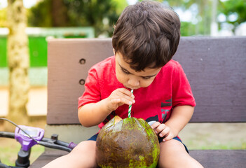 2 year and 10 month old boy drinking cold coconut water