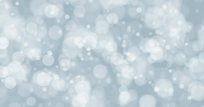Blurred white blue winter bokeh loop slow motion background. Concept Christmas and New Year decoration.