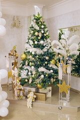 Vertical restaurant cafe room green Christmas Tree gifts presents garlands, candles decorated interior New Year beautiful lights glowing in the evening
