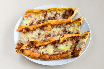 Kiymali pide.Turkish pide with minced meat. Turkish pizza mince pita Pide on white background. Etli ekmek. Kusbasi kasarli, kiymali kasarli, kiymali yumurtali,  tirnak Trabzon, Bafra, Kusbasili pide.