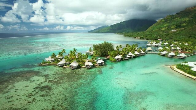 Drone aerial Tahiti 4k. Aerial view of tropical paradise Moorea island, turquoise crystal clear water lagoon, overwater bungalows. French Polynesia.