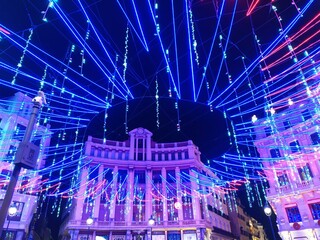 Christmas lighting at night in the city center
Madrid street illuminated by colorful lights.