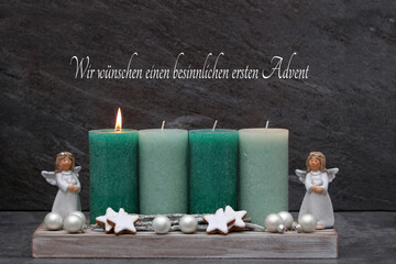 Erster Advent: Schlichte Adventsdekoration mit grünen Kerzen, Engel und Zimtsternen.	
