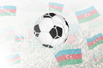 National Football team of Azerbaijan scored goal. Ball in goal net, while football supporters are waving the Azerbaijan flag in the background.