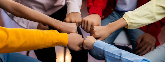 Startup company employee team stacking hand together symbolize successful group of business...