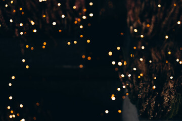 Decorative string lights at night time, Defocused Background, night city backdrop, party time with Yellow bokeh balls. - obrazy, fototapety, plakaty