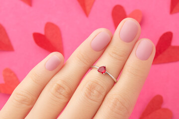 Womans hand with trendy pink matte manicure close-up. Beauty treatment spa body care 