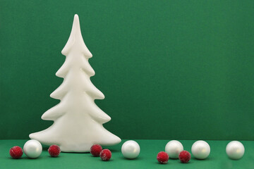 Christmas card with Christmas tree decorations and balls on a green background with place for text