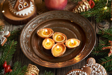 Beeswax Christmas candles floating in a bowl of water