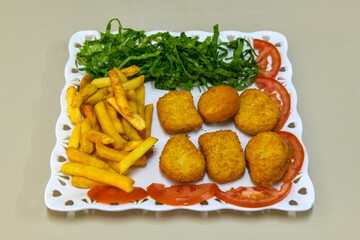 Fried Chicken breast hot crispy strips crunchy chicken tenders  isolated on white background.Nuggets isolated on white background on a plate