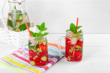 Two glasses with drink of fresh ripe berries on beautiful towel