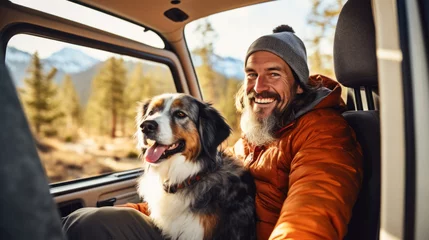Poster happy dog with owner sitting in their camper van © zayatssv