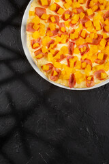 Artisanal Hawaiian pizza with pineapple, ham, and mozzarella