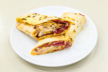 Lavash doner kebab ( zurna doner durum )  or shawarma sliced in plate isolated.  Tavuk Et Doner...