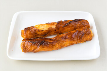 Turkish style meat stuffed filo dough borek served kol boregi. Cheese and minced pie are sliced on a marble background. Turkish name: Kol Boregi, ispanakli, kiymali, Su Boregi