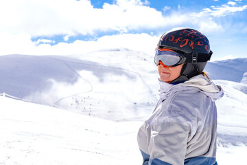 Active senior experienced mature women in winter overalls,ski mask on snow hill at high Carpathian mountains at alpine ski sport resort,nature landscape,Ukraine,Europe