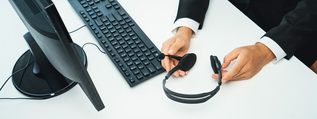 Business people wearing headset working in office to support remote customer or colleague. Call...