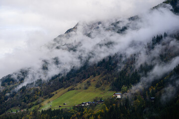 mountain landscape in the austrian alps 
with clouds and fog