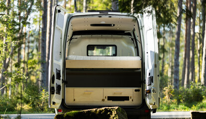 Camper van conversion back doors open with wood interior in Norway forest - obrazy, fototapety, plakaty