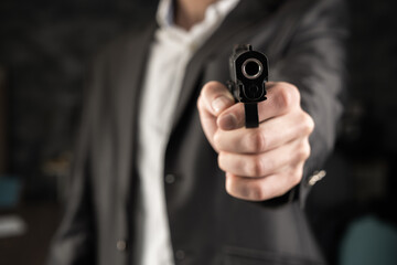Naklejka premium A man in a suit pointed a gun