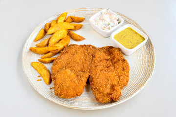 Fried Chicken breast hot crispy strips crunchy chicken tenders  isolated on white background.Nuggets isolated on white background on a plate