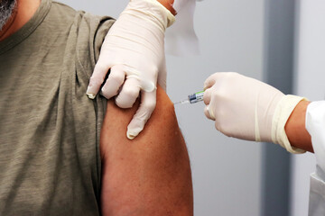 Flu vaccine. Nurse gives flu shot to a man. Hospital, clinic, infirmary