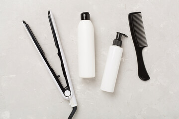 Hair straightener with thermo protection on concrete background, top, view