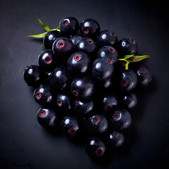 Bunch of black berry's are sitting on a dark kitchen worktop
