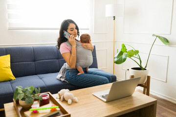 Working mom taking care of her child and doing remote work