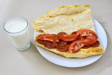 Grilled chili, tomato and sucuk between bread. ( Sucuk ekmek ) 