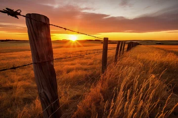 Papier Peint photo Canada Sunrise over Alberta s prairie grasslands behind a wooden barbed wire fence
