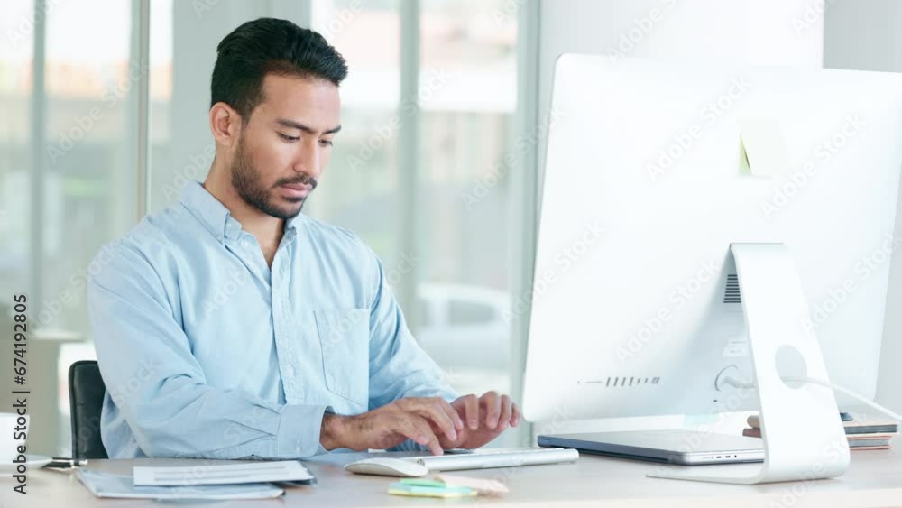 Poster Financial manager or investment banker reading fiance report while typing an email. Young and focused male worker looking busy, typing data into an online system on a computer for client information