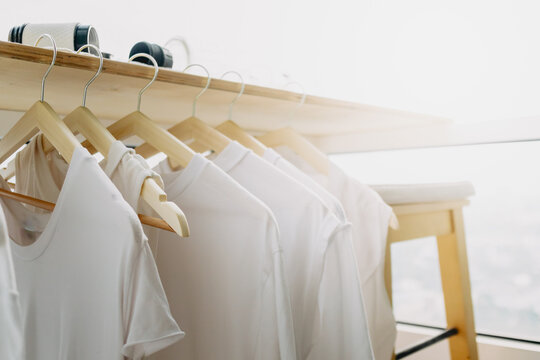 Hanging white clothes on the balcony in the apartment. Wash and laundry.