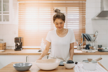 Obraz na płótnie Canvas Portrait of happy asian woman preparing breakfast in the kitchen in the morning.